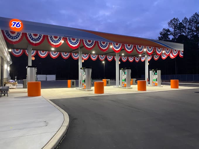 76 station canopy with red, white and blue bunting at dusk.